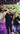 Thomas Shaw and Nicole Pape in front of a ROQ YOU M P9 on purple carpet at a tradeshow both wearing black tees with ROQ logo on them