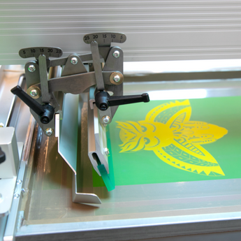 Close up of Screen with Yellow owl being printed on ROQ NEXT P16 XL Automatic Screen Printing Press